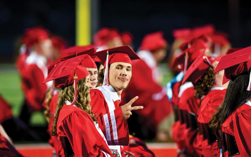 Wade Cheek/The Clayton Tribune. RCHS senior Andy Nolan says “peace out” to the camera just before he gets his diploma at Rabun County’s graduation ceremony on Friday, May 23.