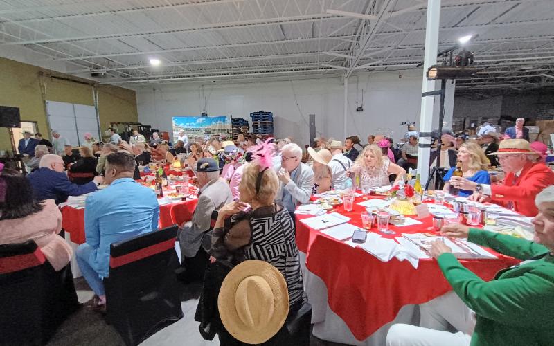 Megan Horn/The Clayton Tribune. Hundreds of people attended the Rotary Club of Clayton Run for the Roses event held at the Food Bank of Northeast Georgia on Saturday, May 3, to help raise money for youth services in Rabun County. The event featured auctions, dancing, dining and dapper attire as well as a live telecast of the 151st Kentucky Derby.