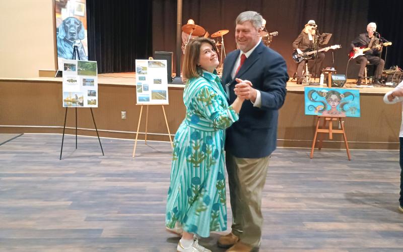 Megan Horn/The Clayton Tribune. Jennifer Arbitter, left, and Dr. Stephen Arbitter, COO of Rabun Paws 4 Life Board of Directors, enjoy music by Sweet Charity’s Playing It Forward and dancing during last weekend’s Fur Ball.