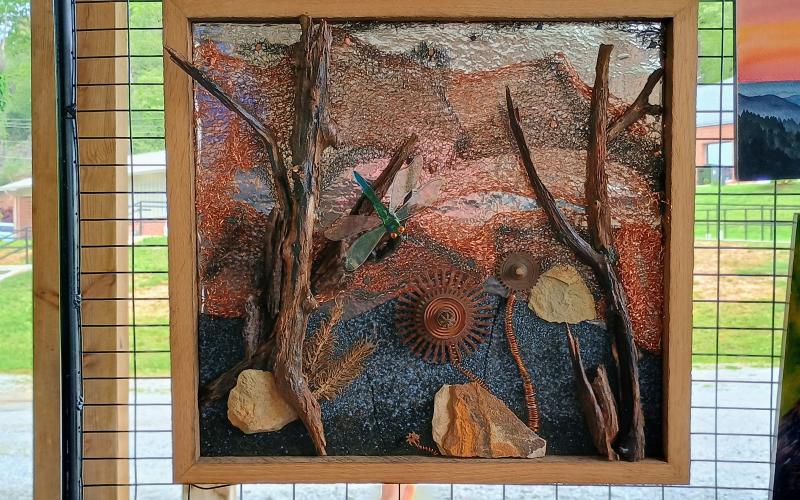 Megan Horn/The Clayton Tribune. Paul Pieringer with Macon County Art Association Uptown Gallery showcased his assemblage sculptures and this intricate painting at the Sassfras Artisan Market presented by the North Georgia Arts Guild last weekend.