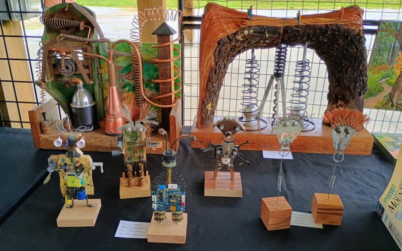 Megan Horn/The Clayton Tribune. Paul Pieringer with Macon County Art Association Uptown Gallery showcased his assemblage sculptures in these robot forms at Sassfras Artisan Market presented by the North Georgia Arts Guild last weekend.