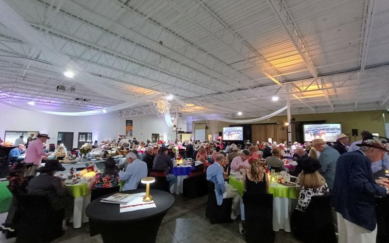 Megan Horn/The Clayton Tribune. Hundreds of people attended the Rotary Club of Clayton Run for the Roses event held at the Food Bank of Northeast Georgia on Saturday, May 3, to help raise money for youth services in Rabun County. The event featured auctions, dancing, dining and dapper attire as well as a live telecast of the 151st Kentucky Derby.