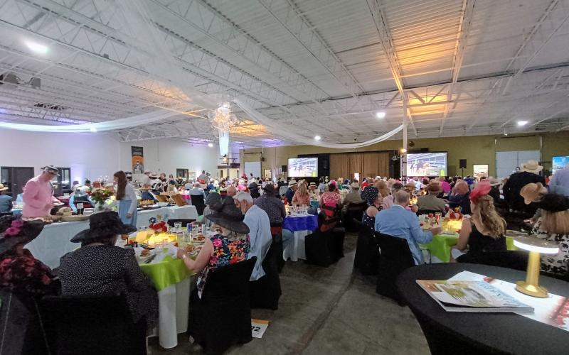 Megan Horn/The Clayton Tribune. Hundreds of people attended the Rotary Club of Clayton Run for the Roses event held at the Food Bank of Northeast Georgia on Saturday, May 3, to help raise money for youth services in Rabun County. The event featured auctions, dancing, dining and dapper attire as well as a live telecast of the 151st Kentucky Derby.