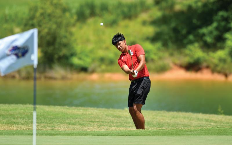 Wade Cheek/The Clayton Tribune. Junior golfer Roberto Diaz chips up onto the green during this week’s Class A-Division I state tournament. Diaz finished seventh as an individual, leading Rabun to an eighth-place finish.