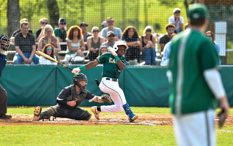 Wade Cheek/The Clayton Tribune. Senior infielder Denajh Williams cracks a base hit through the outfield during Rabun Gap’s 8-0 win over Tallulah Falls School.