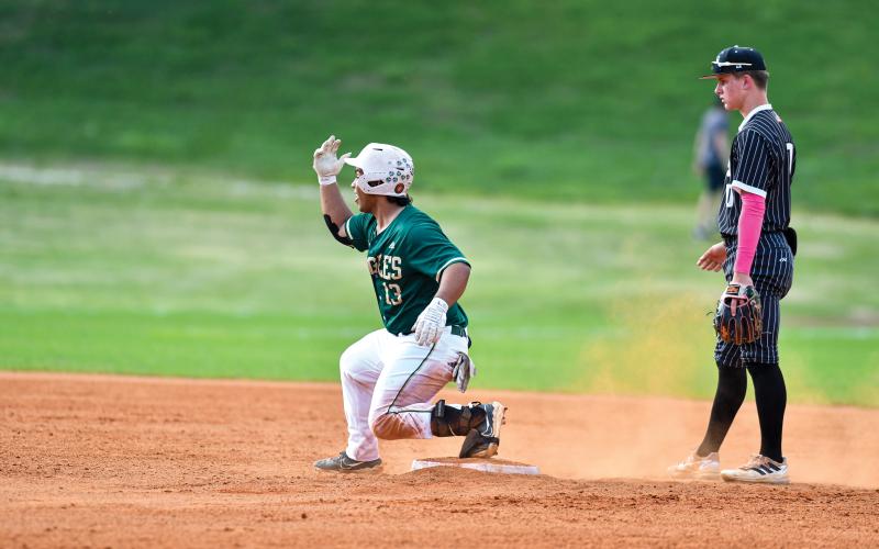 Wade Cheek/The Clayton Tribune. Senior catcher Jeffery Diaz celebrates with the dugout after smashing a double against Tallulah Falls School on April 30.