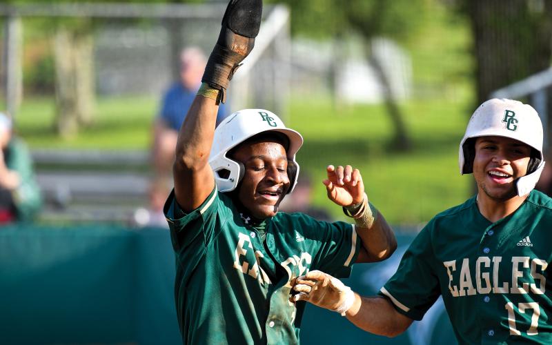 Wade Cheek/The Clayton Tribune. Rabun Gap senior infielders Denajh Williams (left) and Brenden Rosado (right) celebrate runs in their win over Tallulah Falls School. The Eagles have stayed hot since, scoring 12 runs in their most recent win over Christ School.