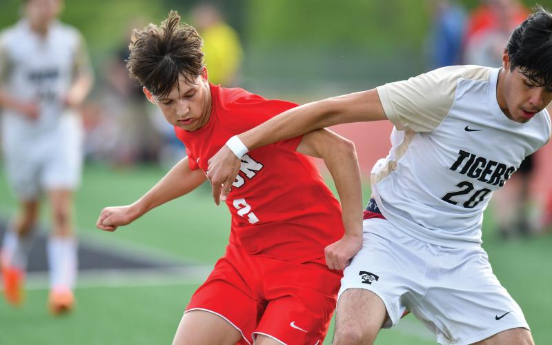 Wade Cheek/The Clayton Tribune. Senior Cameron Blalock gets physical with a Temple defender in last Friday’s second-round match of the Class A-DI state tournament.