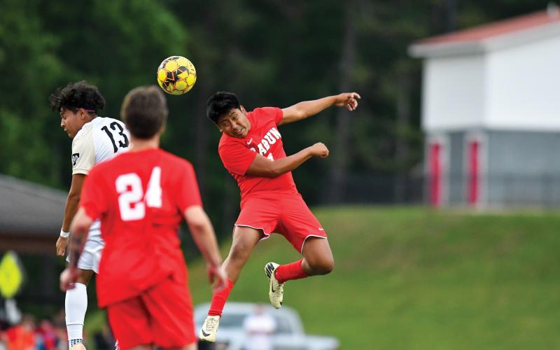 Wade Cheek/The Clayton Tribune. Junior Christian Avila headers a ball in last Friday’s playoff win over Temple. Avila is the team’s leading goal scorer.