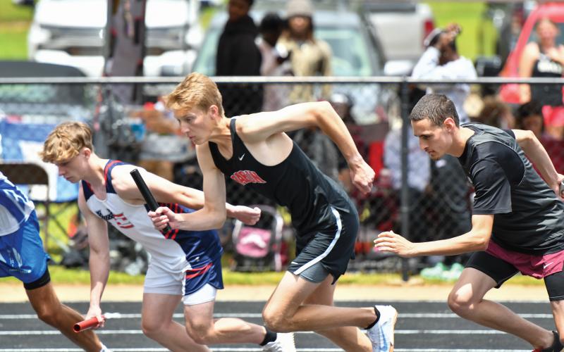 Wade Cheek/The Clayton Tribune. Senior distance runner G.B. Anderson kicks off the first leg of the 4x800m relay for the Rabun County boys team. The Wildcats finished eighth, qualifying for the state meet.