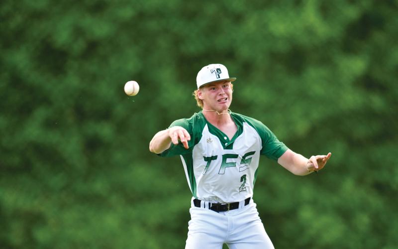 Wade Cheek/The Clayton Tribune. After his glove was knocked off by a line drive to the mound, pitcher Chase Pollock records an out in Tallulah Falls’ Game 1 loss in the playoffs to Stratford Academy.