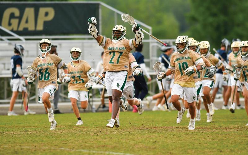 Wade Cheek/The Clayton Tribune. The Rabun Gap-Nacoochee School boys lacrosse team celebrates its quarterfinal victory over Charlotte Latin on Friday, May 9. The Eagles advanced to the semi-final round for the first time in program history.