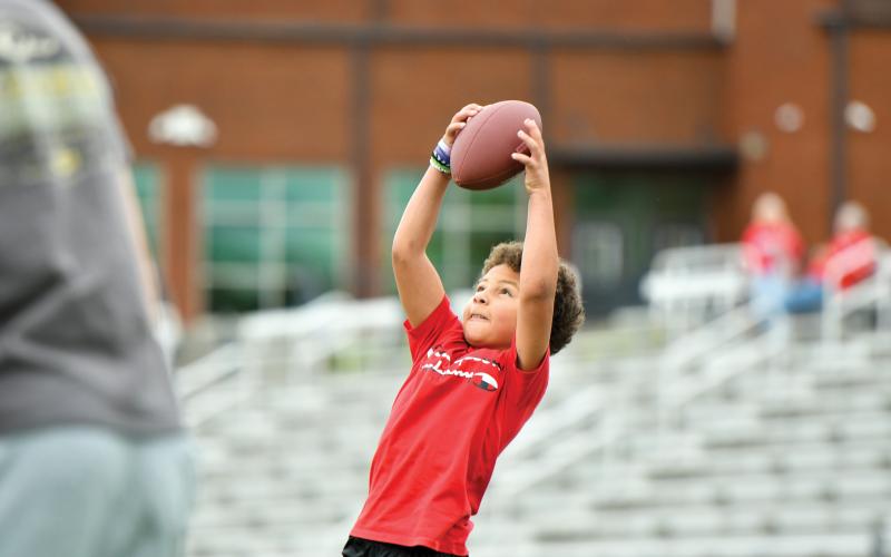 Wade Cheek/The Clayton Tribune. Rabun County local Hudson Hamby snags a catch in a wide receiver drill during Rabun football’s kids football camp on Saturday, May 10.