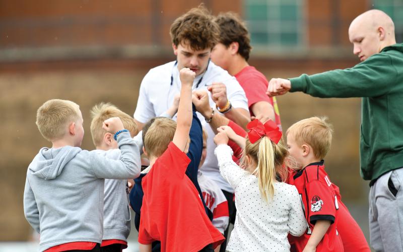 Wade Cheek/The Clayton Tribune. Rising senior running back Lake Evans breaks the huddle down with a group of campers at Rabun County football’s youth camp on Saturday, May 10. The Tri-State camp had former Wildcat standouts Charlie Woerner and Bailey Fisher in attendance for the youth.