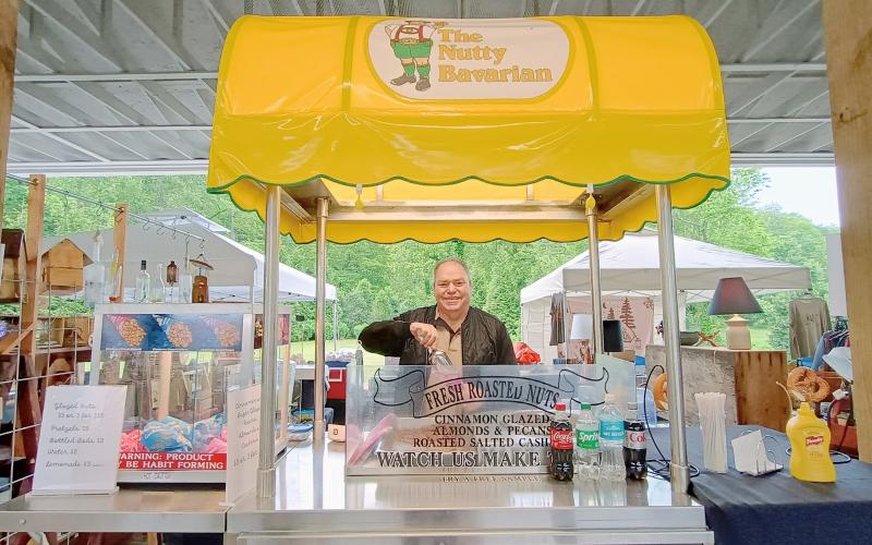 Megan Horn/The Clayton Tribune. Dale Williams sells pretzels and peanuts from The Nutty Bavarian during last Saturday’s Of These Mountains MarketPlace.