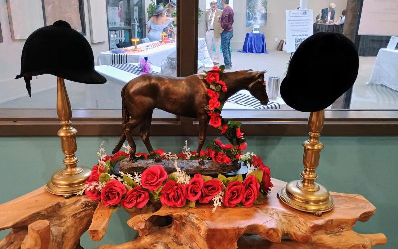 Megan Horn/The Clayton Tribune. The Food Bank of Northeast Georgia was decorated in Kentucky Derby faire and transformed into Churchill Downs for the Rotary Club of Clayton’s Run for the Roses fundraiser event Saturday, May 3. Hundreds of people attended to raise money for youth services in Rabun County.