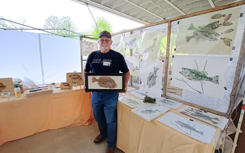 Megan Horn/The Clayton Tribune.  Weylon Robinson displayed his artistic creations featuring fish he catches at Sassafras last weekend.