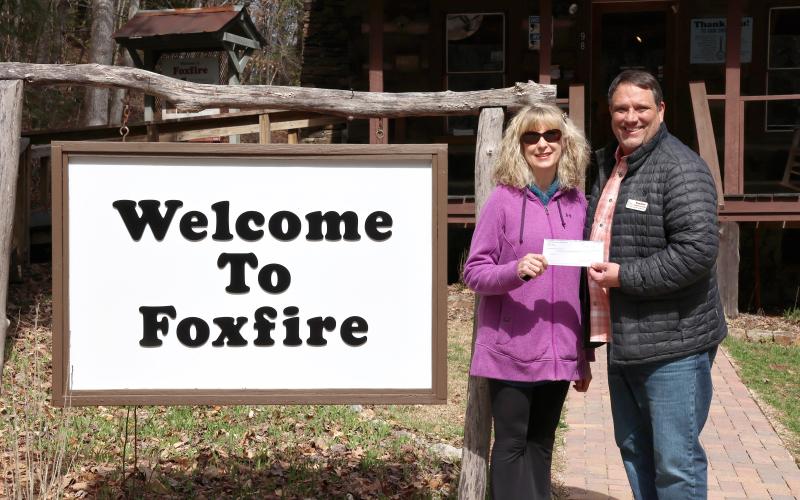 Megan Horn/The Clayton Tribune. Karen Bacon, Rotary Club of Clayton Foundation chair (left), presents Foxfire Executive Director Todd Faircloth with proceeds in March to help fund the removal of trees on the Foxfire property.