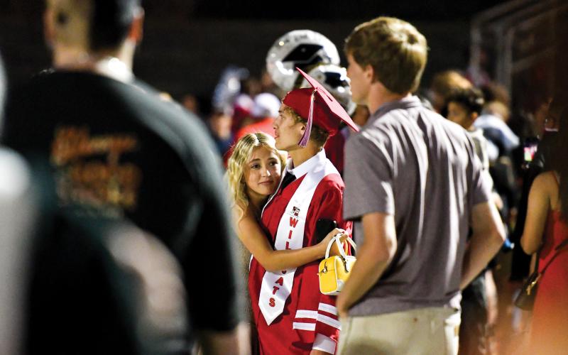 Wade Cheek/The Clayton Tribune. Rabun County High School graduate Jace Crawford receives a hug from his sister Braylee Reed.