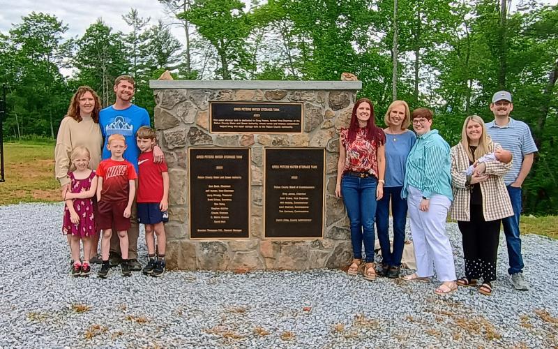 Megan Horn/The Clayton Tribune. Community members attended a dedication ceremony of the 750,000-gallon, ground-level water storage tank located on Yorkhouse Road in Rabun Gap. Pictured are Peters’ family members including Sarah Peters, Joel Peters, Joanna Radford, Susan Peters, Jennifer Peters, Jaimie Crane holding Susie in her arms, John Crane, Eloise Peters, Xander Peters and Tatham Peters.