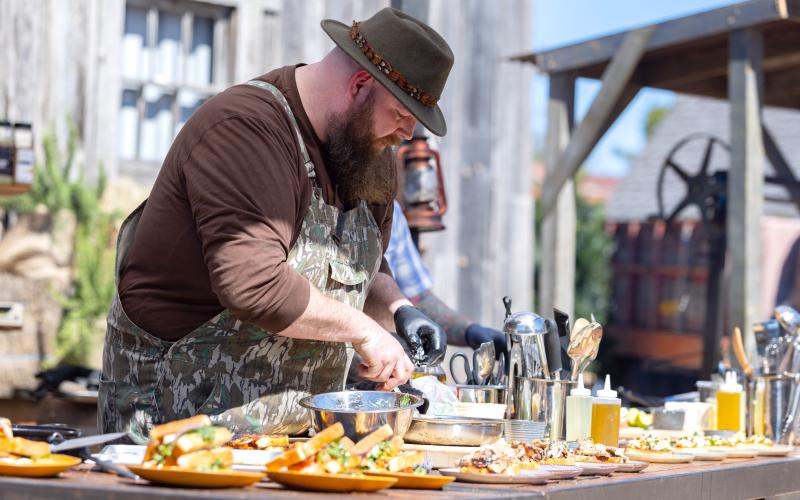 Photo courtesy the Food Network. Bryner prepares some plates of barbecue during one of the tapings of the “BBQ Brawl.”