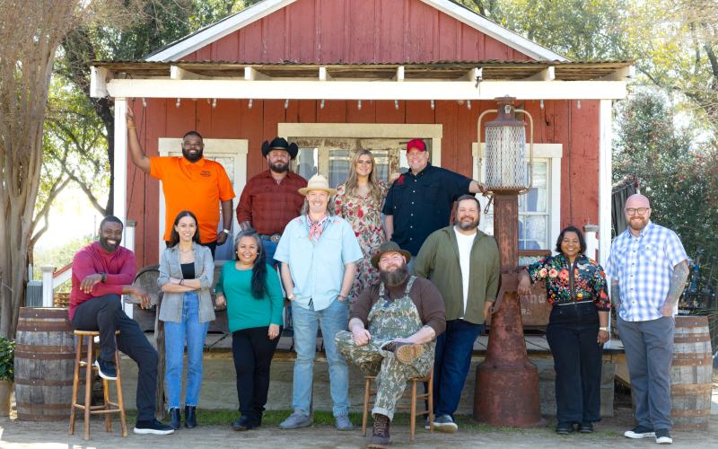 Photo courtesy the Food Network. Kyle Bryner, owner of Blue Hound Barbecue &amp; Grill in Dillard, will be one of the contestants on the Food Network’s “BBQ Brawl” contest. ABOVE: Bryner (seated, center) poses for a photograph with the other competitors on this season’s reality show.