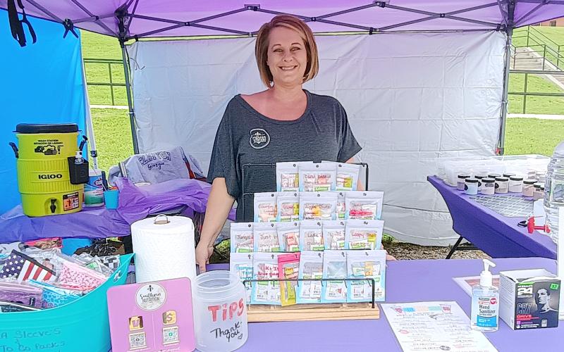 Megan Horn/The Clayton Tribune. Michelle Bruner with the Clayton business, Southern Nutrition, displayed items they have to offer during the May 10 Of These Mountains Spring MarketPlace.