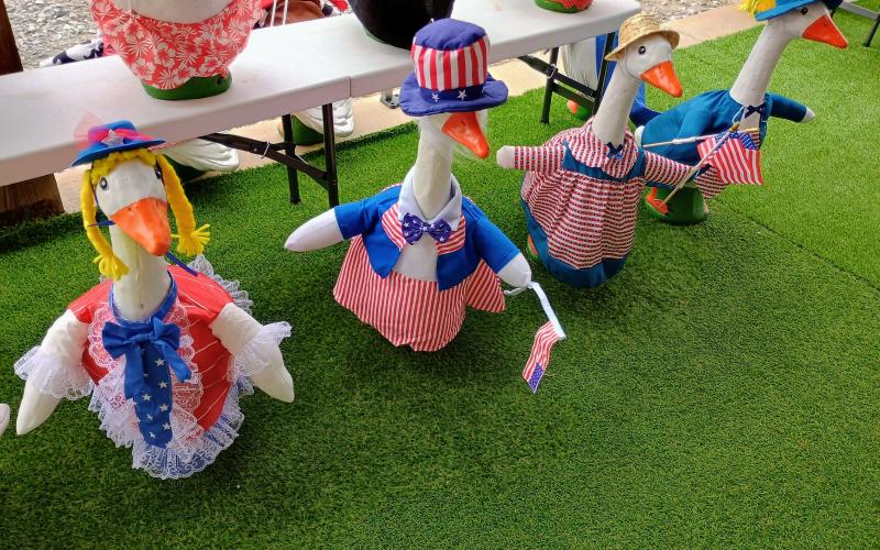 Megan Horn/The Clayton Tribune. These patriotic geese are ready for someone’s porch just in time for Independence Day. It was created by Matt and April Ainsworth through their business The Loose Goose and displayed during last weekend’s Of These Mountains MarketPlace.