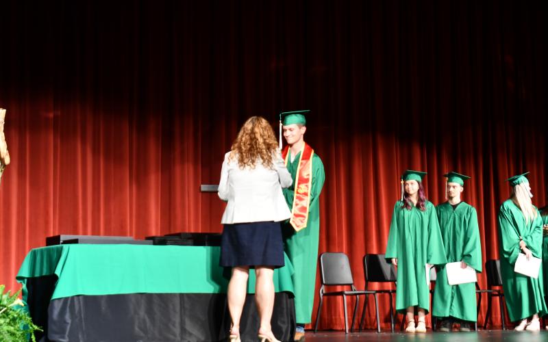 Megan Horn/The Clayton Tribune. 2025 Rabun Mountain Education graduate Joseph Keith Bramblett smiles as he accepts his high school diploma during the May 28 graduation ceremony.