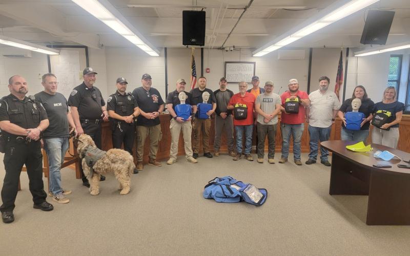 Submitted photo. City of Clayton officials, employees and Clayton Police Department Officers take part in Hands-Only CPR and Automated External Defibrillator (AED) Training at Clayton City Hall on May 14. Rabun County EMS Captain Trampes Stancil instructed and refreshed officials on proper usage. The city recently purchased three AEDs to be used for each patrol shift and have on site.