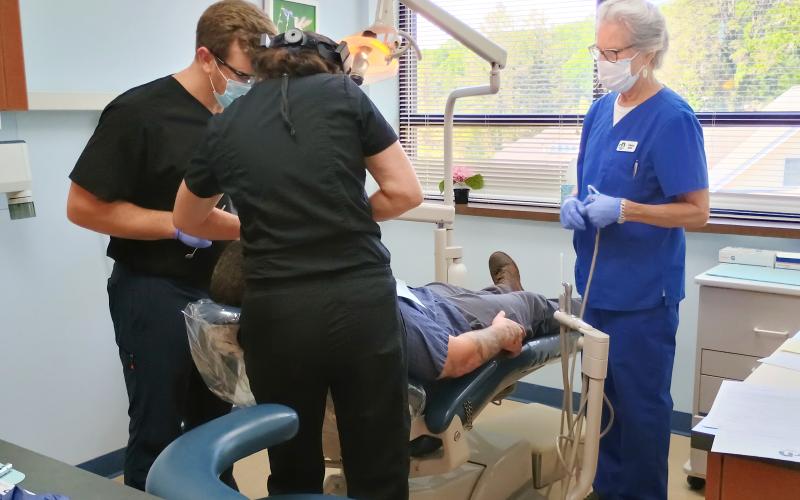 Megan Horn/The Clayton Tribune. Dr. Kyle Daniel, Dr. Mollie Winston and Sherry Spurr volunteer their time helping patients at Community Dental. Since opening in April 2021, it has served over 700 different patients and is open two days a month.