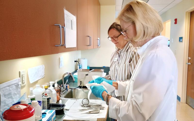 Megan Horn/The Clayton Tribune. Dr. Janet Dunwoody and Jackie Tatum sterilize equipment at the Community Dental Clinic. Both said volunteering at the clinic is rewarding. Community Dental is a dental clinic for low-income adults that opened in April 2021. It operates through the Clayton Rotary Foundation, Inc. 501(c)3.