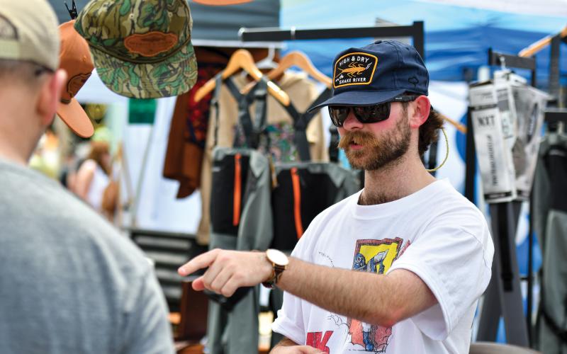 Wade Cheek/The Clayton Tribune. Fly fishing guide and owner of Shady Creek Expeditions Trey McFalls explains what all his business has to offer at Ramshackle on Saturday, June 7.