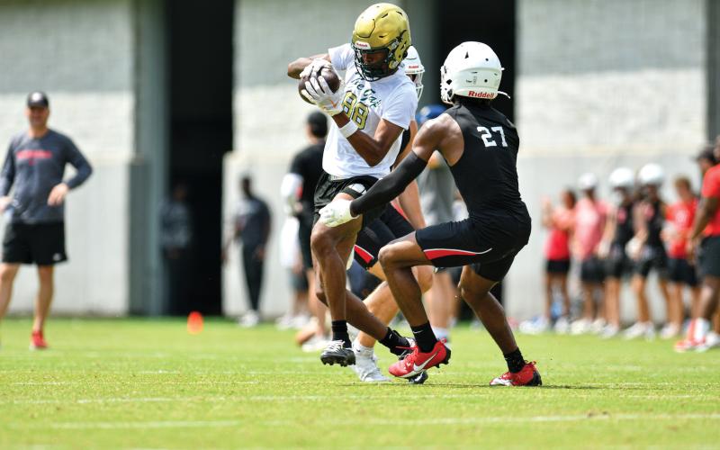 Wade Cheek/The Clayton Tribune. Junior wide receiver Jay Rawls makes a catch amid pressure against North Gwinnett at the Georgia 7-on-7 camp on Tuesday, June 10.