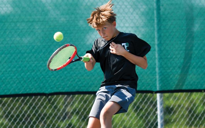 Wade Cheek/The Clayton Tribune. Ethan Alderfer rallies back and forth with his opponent at the Tallulah Falls School kids tennis camp last week.