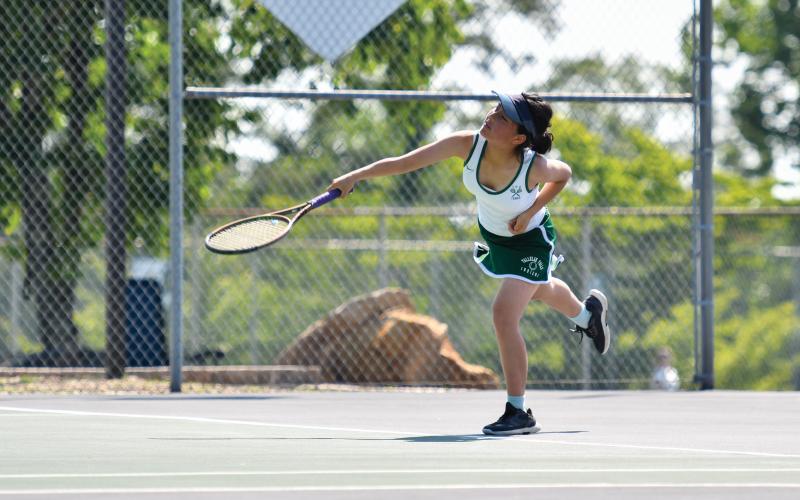 Wade Cheek/The Clayton Tribune. Spring Lin serves to her opponent in match play at TFS.