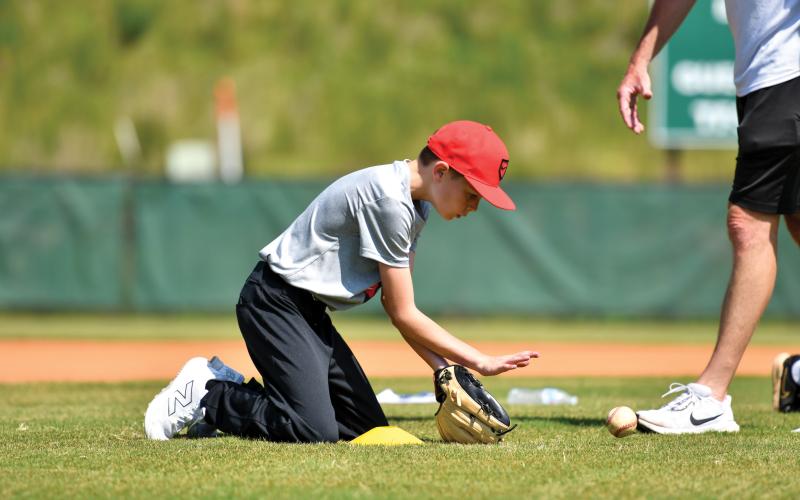 Wade Cheek/The Clayton Tribune. Beckett Simmons cleanly fields a ground ball in an infield drill.