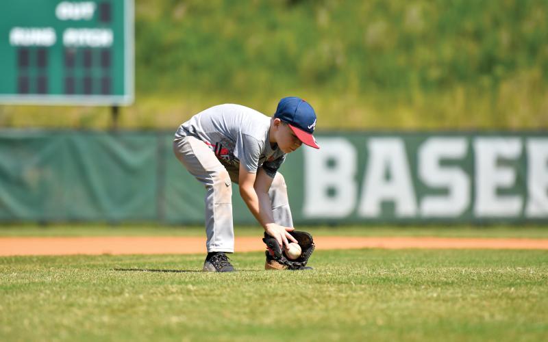Wade Cheek/The Clayton Tribune. Beckett Simmons cleanly fields a ground ball in an infield drill.
