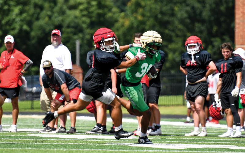 Wade Cheek/The Clayton Tribune. Freshman defensive back Amir Thompson works to collect a tackle during Rabun’s summer bout against Buford High School.