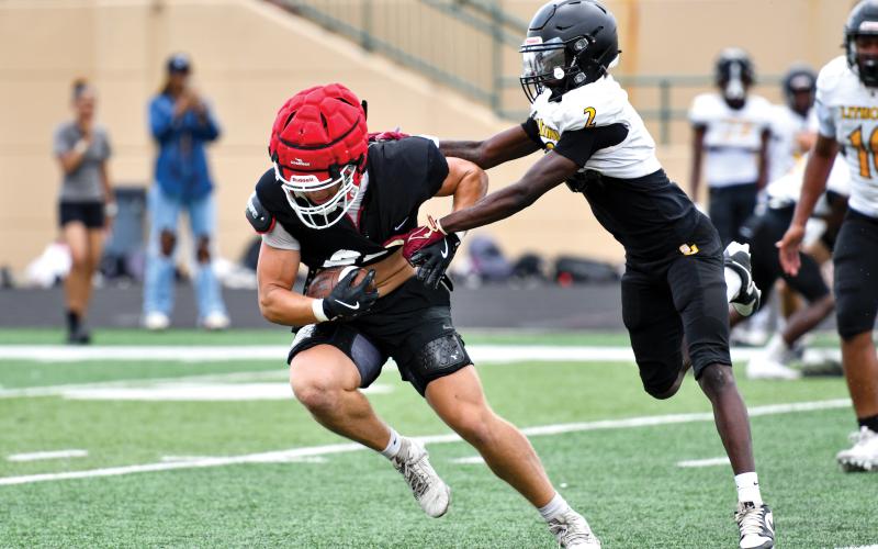 Wade Cheek/The Clayton Tribune. Senior Dane Tyler breaks away from a Lithonia defender during Rabun’s two-day padded camp at Buford High School from Tuesday, June 17, to Wednesday, June 18.