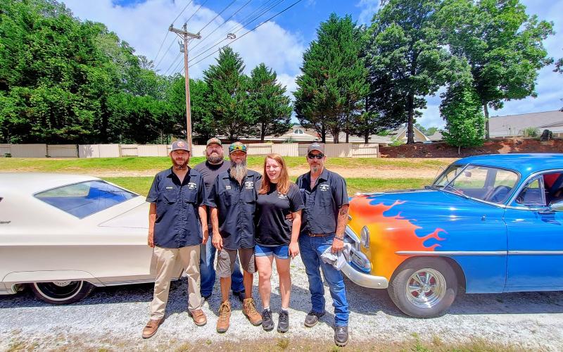 Megan Horn/The Clayton Tribune. Pharoahs Car Club of Clayton, Ga. recently held the “Pharoahs Drive-In Movie Car Show 2025” at the Tiger Drive-In. Pictured are Josh McCannon, colonel for Pharoahs Car Club of Clayton, Ga. left; Calvin Whitmire; Cody Whitmire, general for the Pharoahs Car Club of Clayton, Ga. ; Shanda Whitmire; and E.J. Wall, Sergeant at Arms for the Pharoahs Car Club of Clayton, Ga.