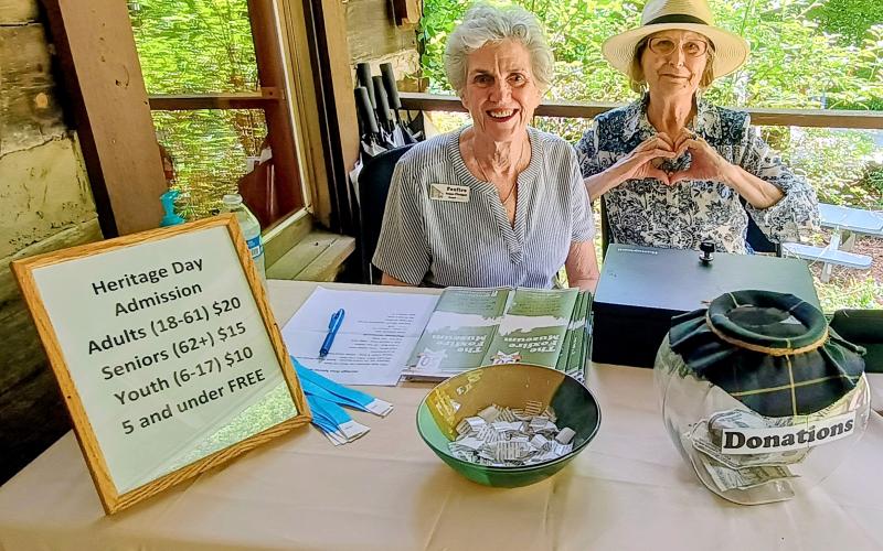 Megan Horn/The Clayton Tribune. Board Member Anne Pledger (left) and Foxfire Associate Sally Dicharry check people in at Foxfire Heritage Days Friday, June 6. The two-day fundraising event was held in Mountain City on Friday, June 6, and Saturday, June 7.