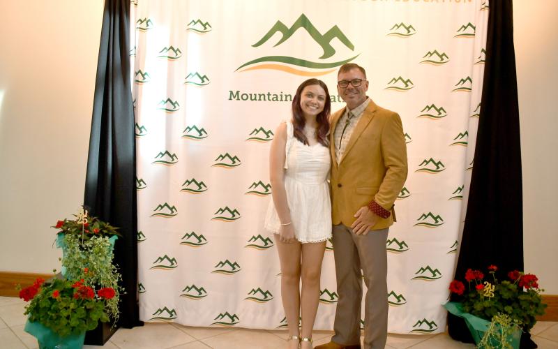 Megan Horn/The Clayton Tribune. Rabun Mountain Education 2025 graduate Krissa Elizabeth Fountain (left) celebrates her high school graduation with father Stacy Fountain during the May 28 graduation ceremony at the Rabun County High School Fine Arts Building (FAB). A reception was held prior to graduates walking across the stage.