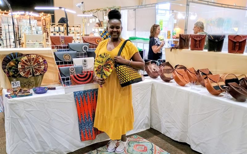 Megan Horn/The Clayton Tribune. Sharon Mumbi with “Africasy” displays her beautiful and colorful handmade bead and leather bags and accessories during the July 12 and 13 Painted Fern Art Festival held at the Rabun County Civic Center. Mumbi is last year’s winner of the “Peoples’ Choice Award for Best in Show.”