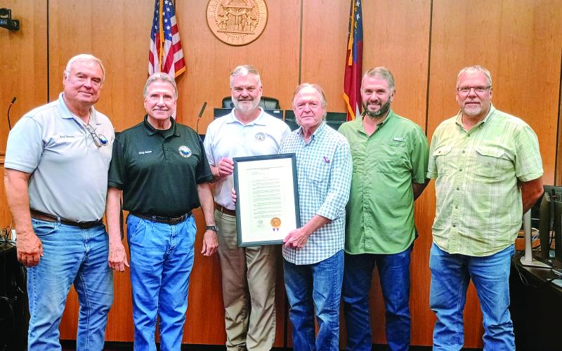 Megan Horn/The Clayton Tribune. Commissioners are presented with a resolution proclaiming Rabun County as the “Waterfall Capital of Georgia” during the July 22 Board of Commissioners meeting. Pictured are Commissioner Kent Woerner, left; Chairman Greg James; Georgia District 10 Rep. Victor Anderson; Andrew Harris, Lake Burton resident who drafted the resolution and spearheaded the designation; and Commissioners Will Nichols and Tom Garrison. Not pictured is Commissioner Scott Crane.