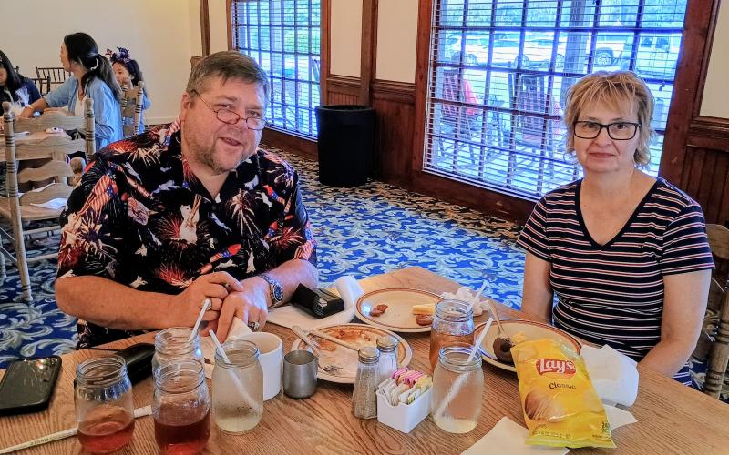 Megan Horn/The Clayton Tribune.  Archie and Stephanie Tabor enjoy a delicious BBQ dinner at The Dillard House on July 4, for the annual Independence Day celebration.