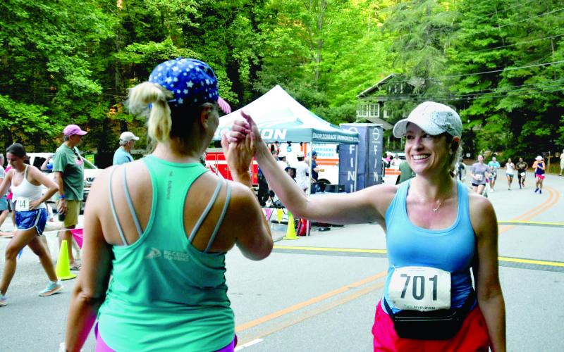 Enoch Autry/The Clayton Tribune. Amanda Roberson and Audrey Roberson congratulate each other after completing the 5K at the Rabun Ramble.