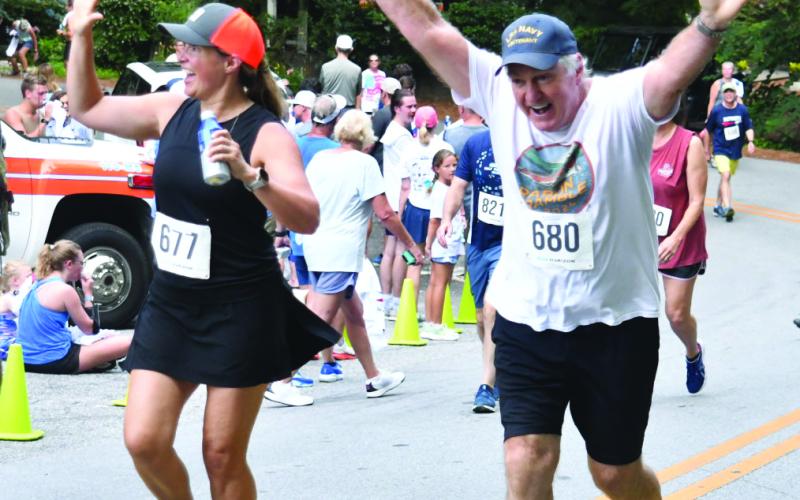 Enoch Autry/The Clayton Tribune. : Allison Belline and Louis Belline are all smiles after completing the Rabun Ramble.