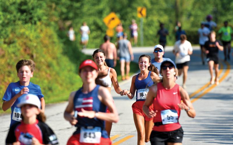 Wade Cheek/The Clayton Tribune. Axel Fiksman of Atlanta (815) was one of the many runners at the Lake Burton Fun Run to dress from head to toe in red, white and blue in celebration of Independence Day last weekend.