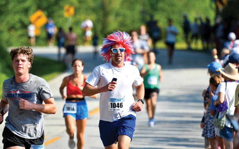Wade Cheek/The Clayton Tribune. Jeff Wilson of Atlanta shows off his patriotism with a red, white and blue wig at the 41st-annual Lake Burton Fun Run.